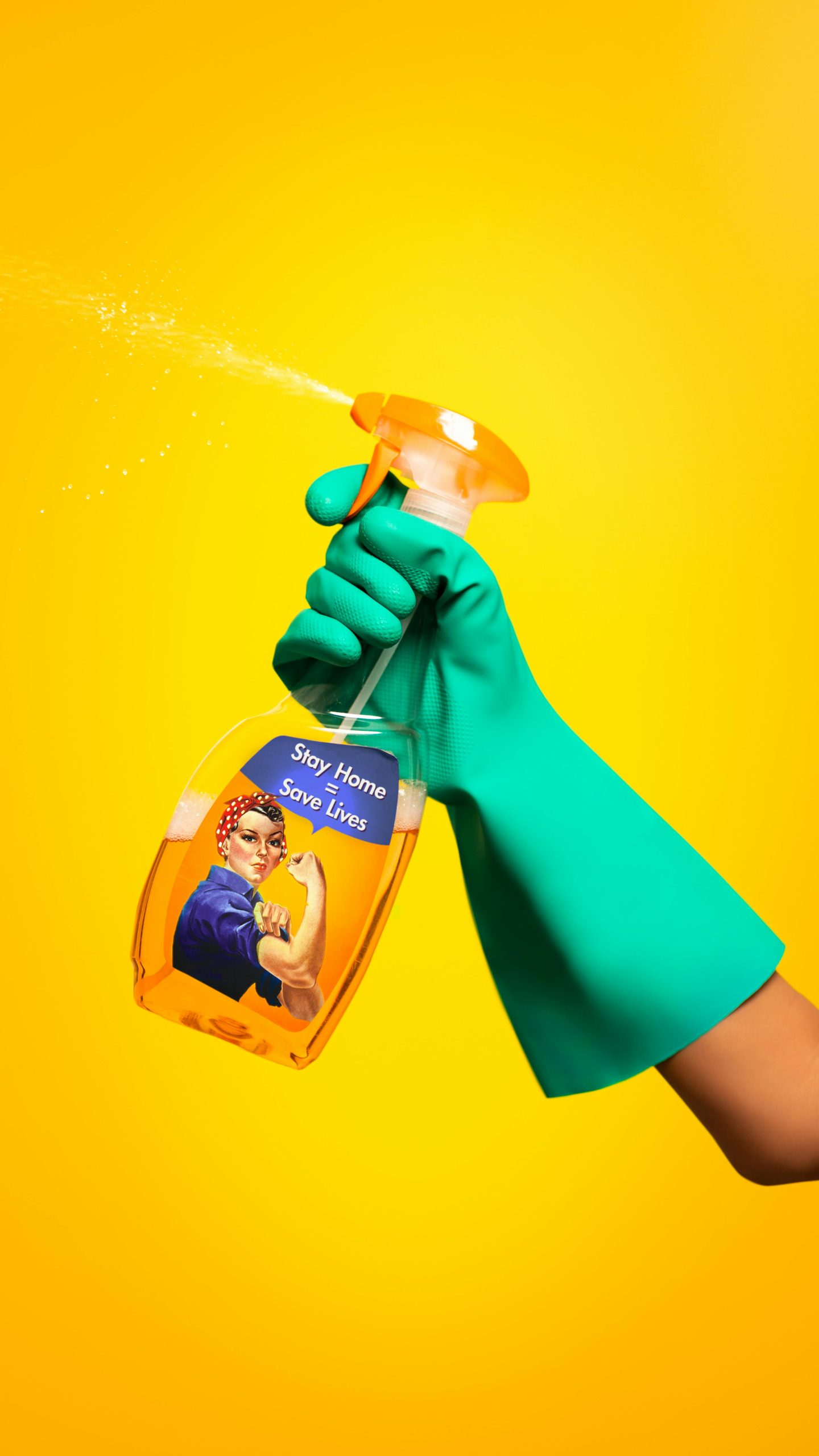 Vibrant image of gloved hand holding spray bottle with 'Stay Home Save Lives' message.